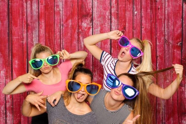 Girls posing with oversized sunglasses in Escondido.