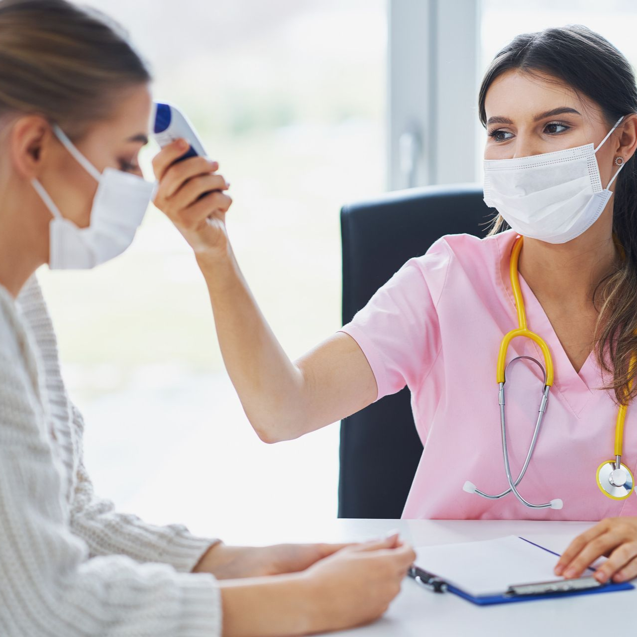 Patient having temperature checked as part of COVID test at Ashworths Clinic Ashford.