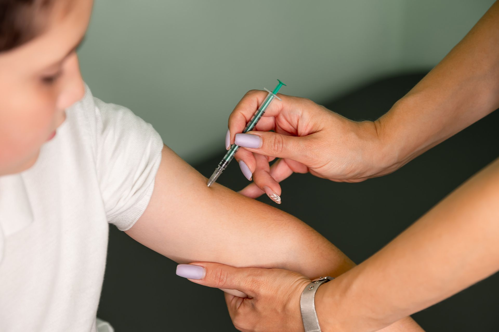 A girl getting a travel vaccination at the Ashworths Clinic before a trip.
