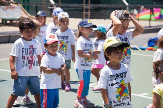 A group of children wearing white shirts that say futuro