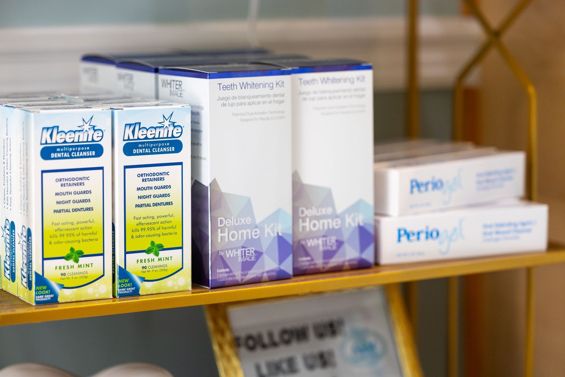 Shelves with dental products: teeth whitening kits, toothpaste, and mouthwash boxes.