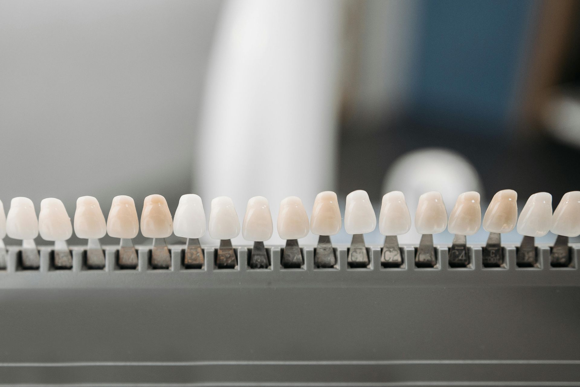 Teeth shade guide showing various tooth color samples, used in a dental office for cosmetic procedures.