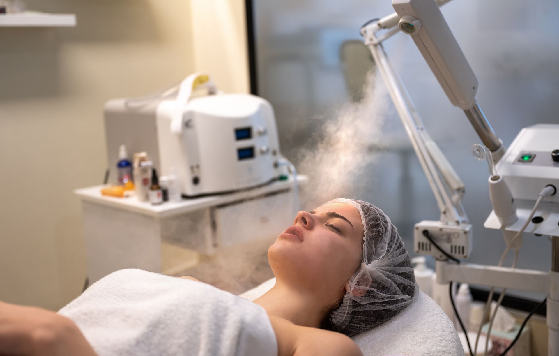 A woman is getting a facial treatment in a beauty salon.