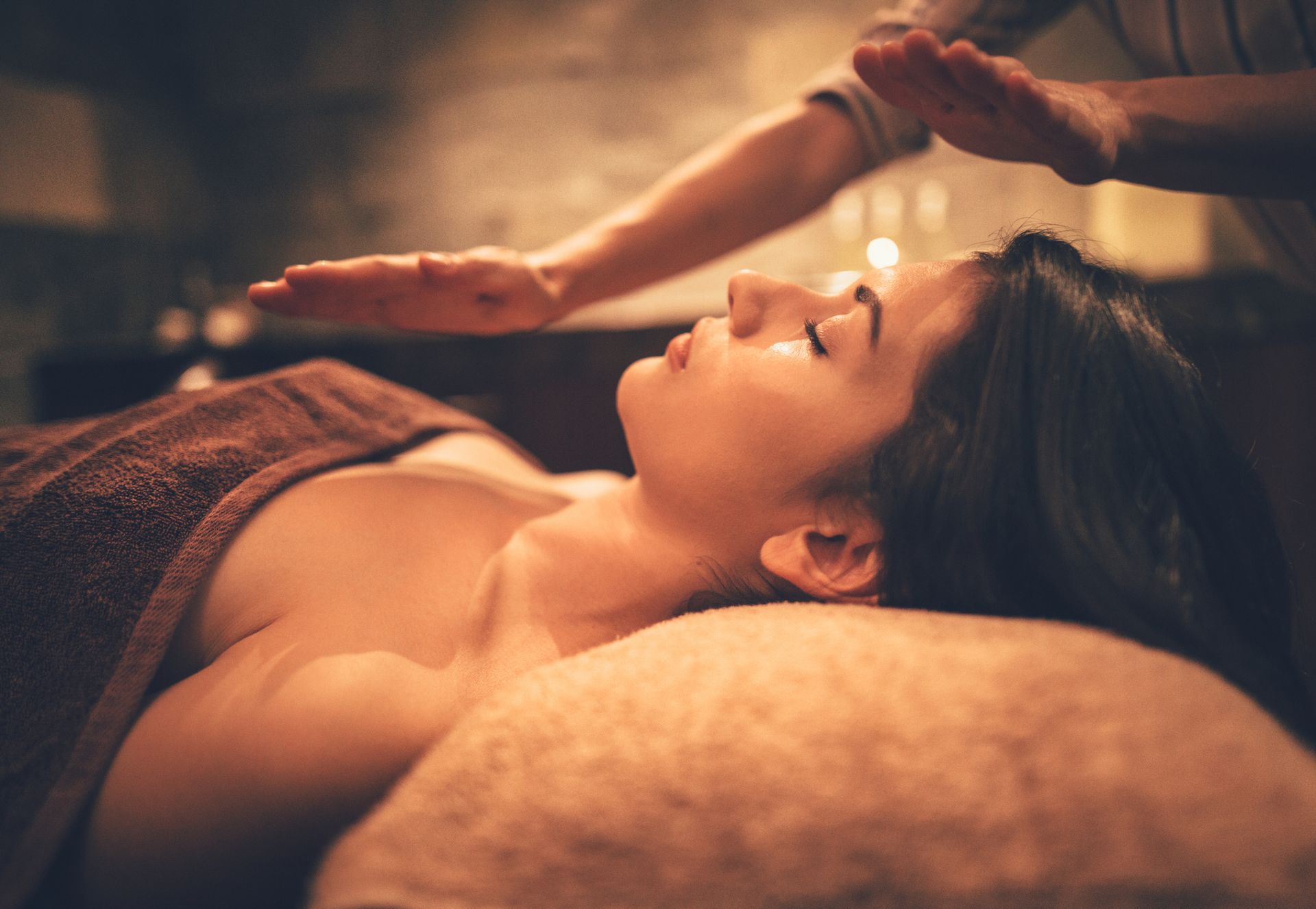 A woman is getting a healing massage at a spa.