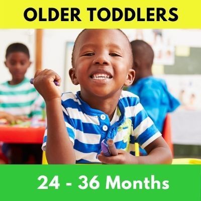 An older toddler, smiling in a classroom, is holding a purple crayon. The text says 