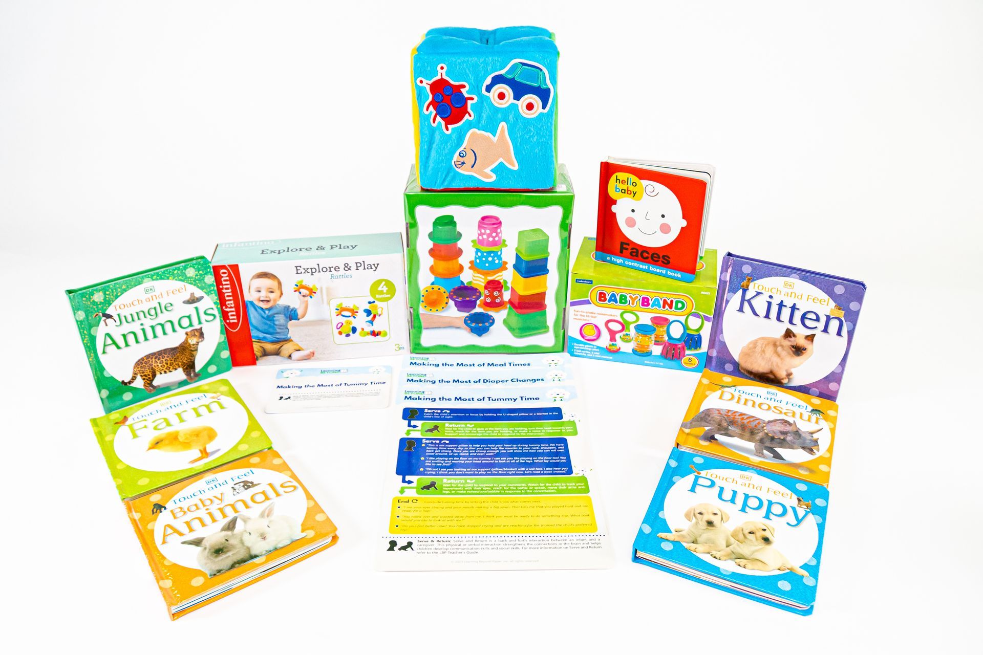 A collection of children's books and stacking toys with bright colors, including animal-themed books and building blocks.