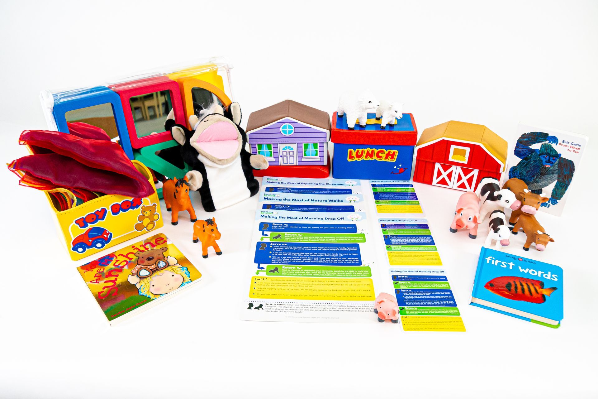 Children's educational farm toy set with a barn, houses, books, farm animal figurines, and flashcards.