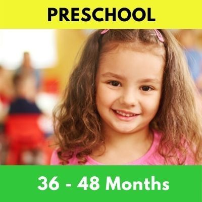 A smiling preschool-aged girl with brown curly hair, in a pink shirt, with the word 