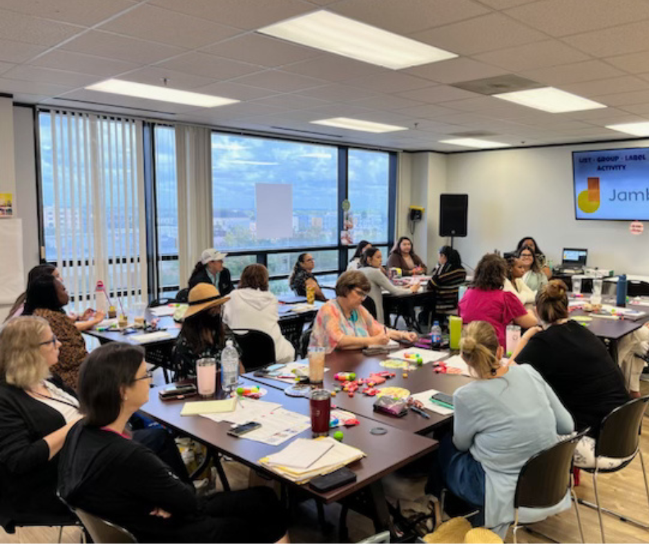 A group of people are sitting at tables in a room.