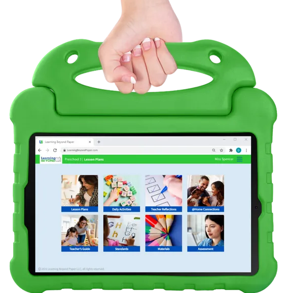 A hand is holding a green tablet with a website on the screen