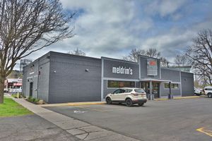 A single-story, dark gray commercial building with 