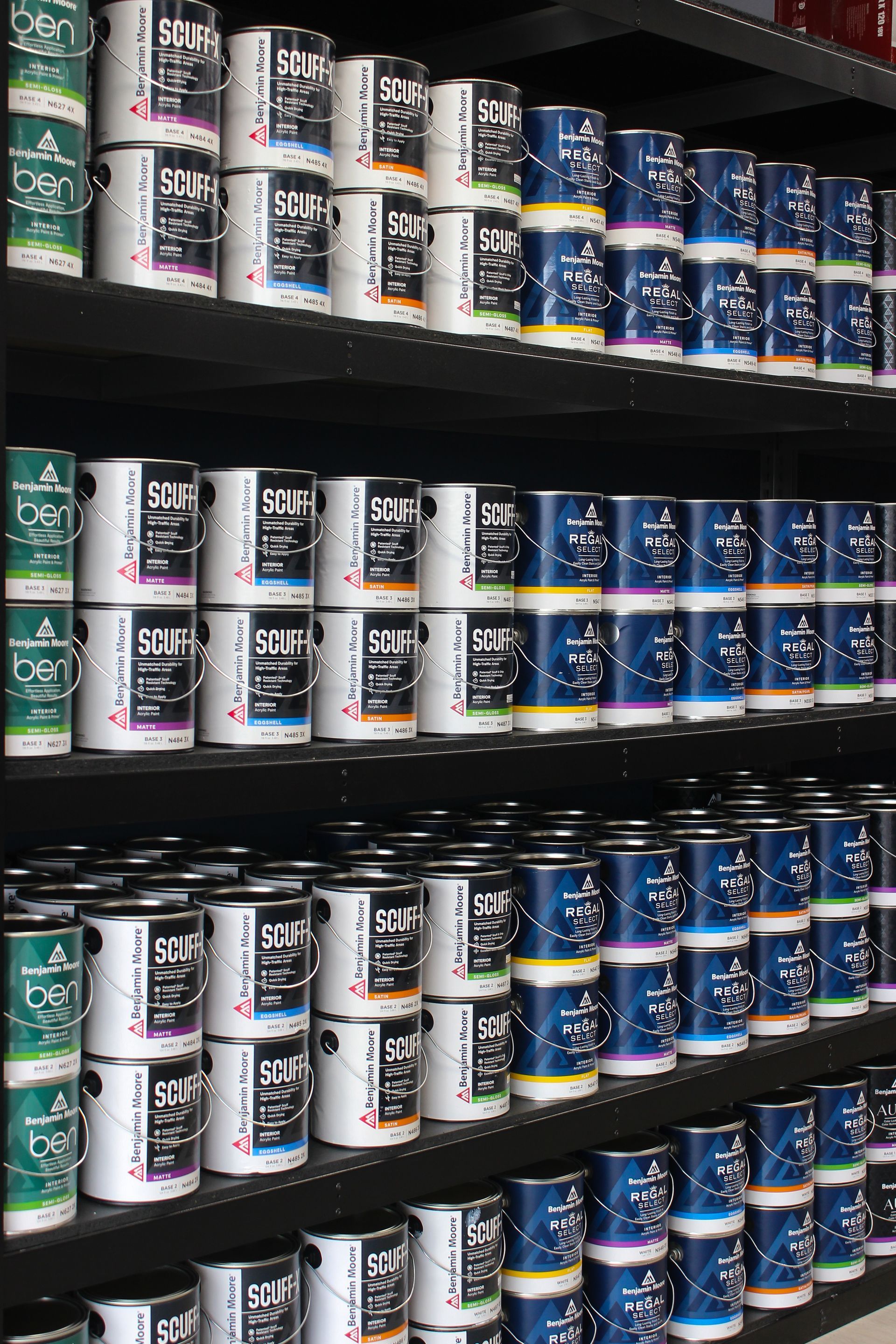 A store shelf filled with lots of cans of paint
