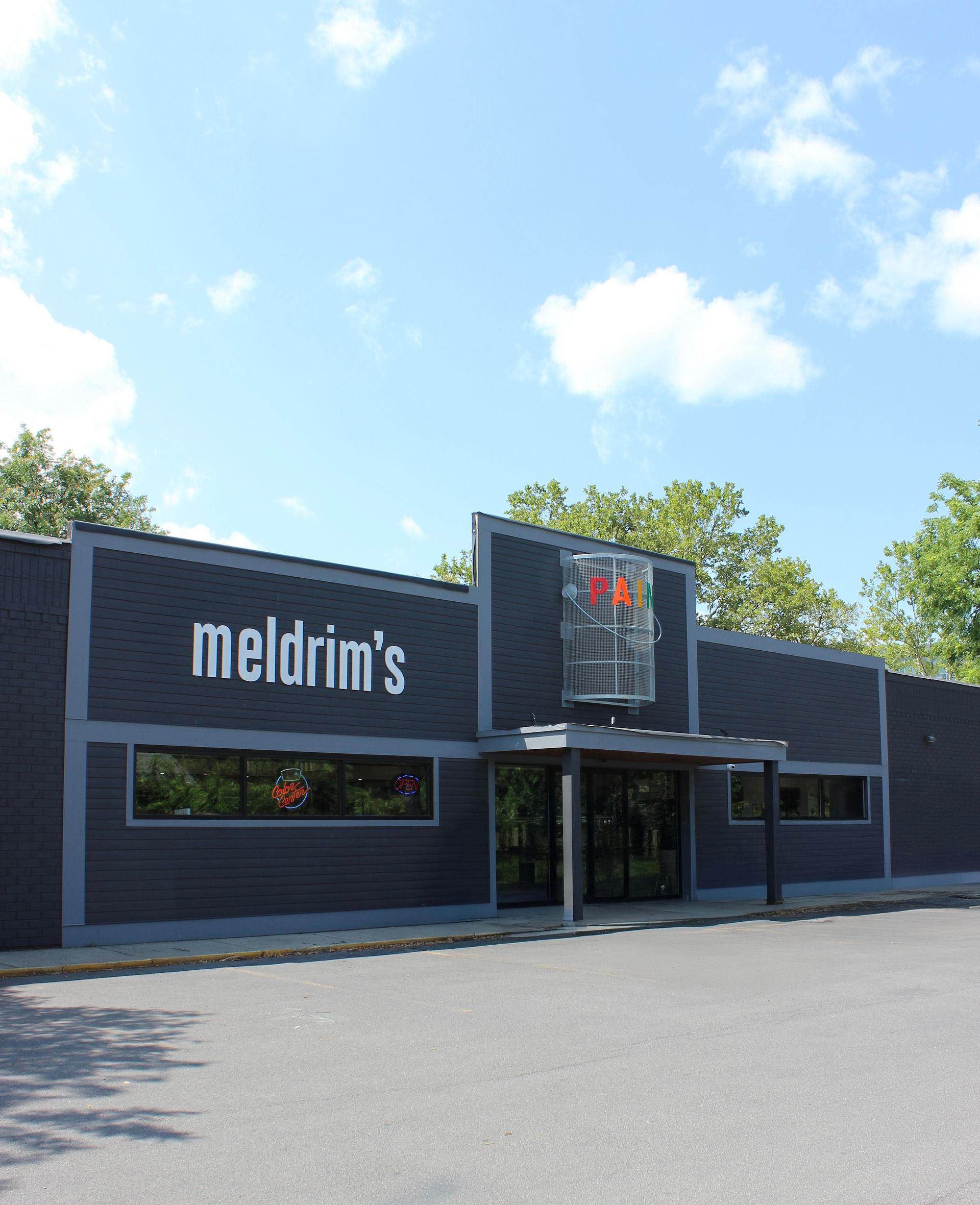 A large black building with a sign on the side of it.