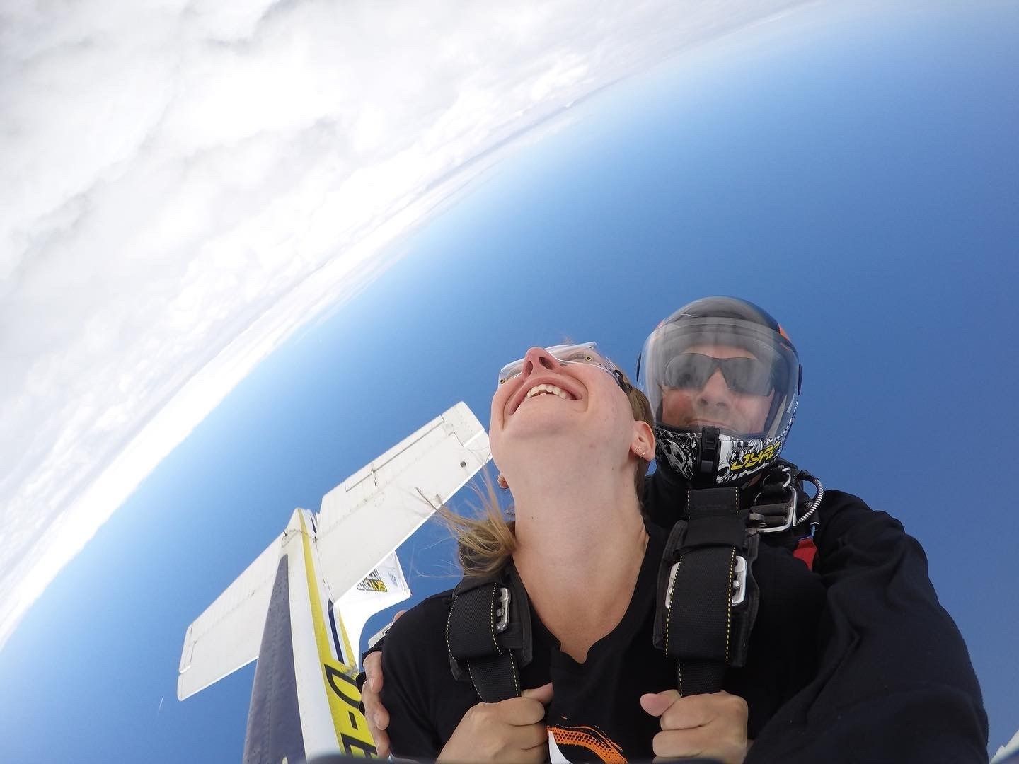 A man and a woman are looking up at the sky.