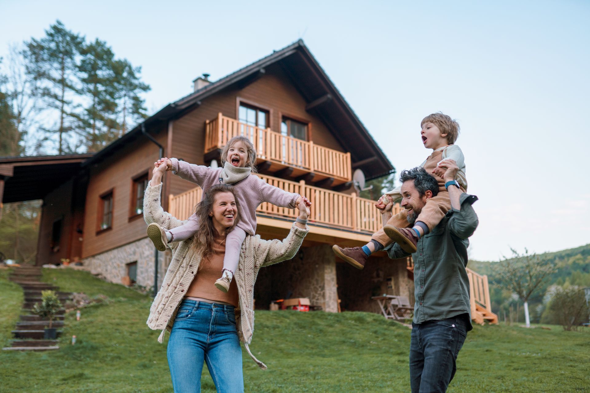 A family is playing in front of a house.