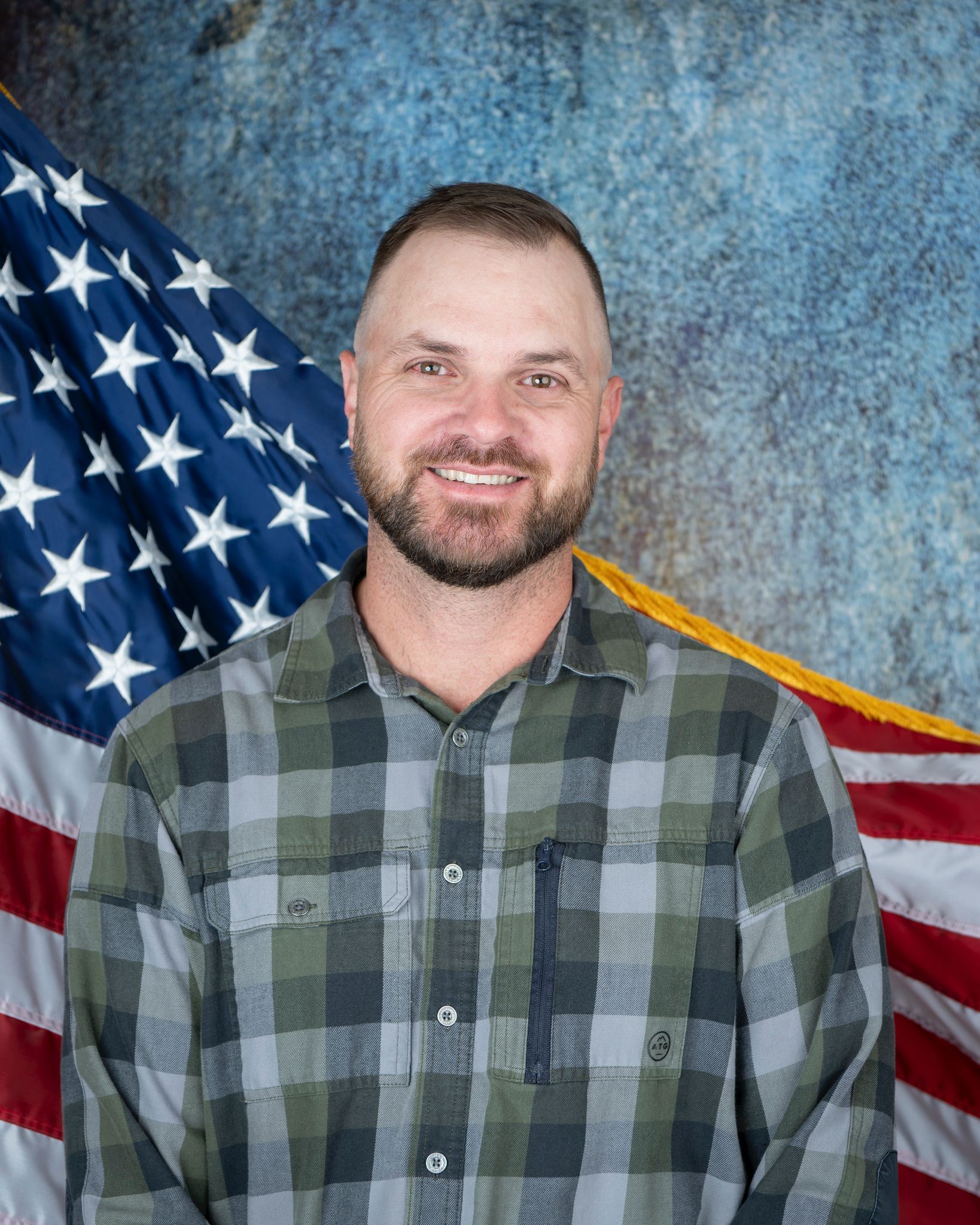 A woman in a black jacket and white shirt is smiling for the camera.
