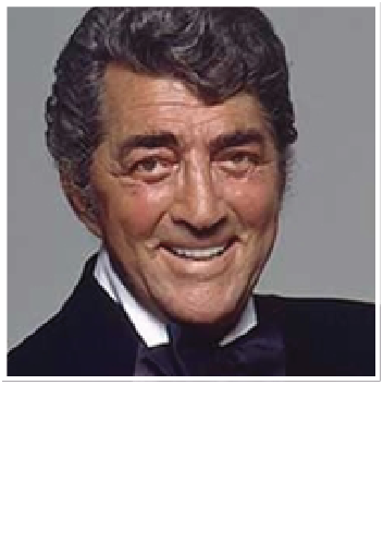 Dean Martin smiling while wearing a dark suit, white collared shirt, and black bowtie against a gray background.