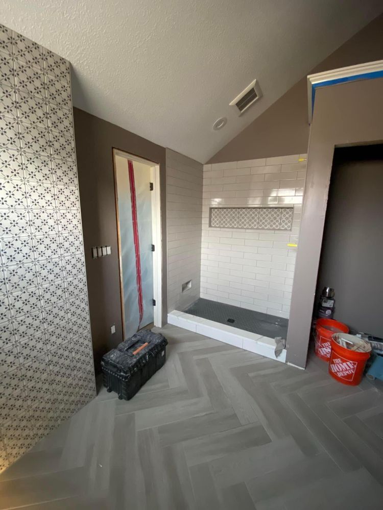 A bathroom with a walk in shower and a box on the floor.
