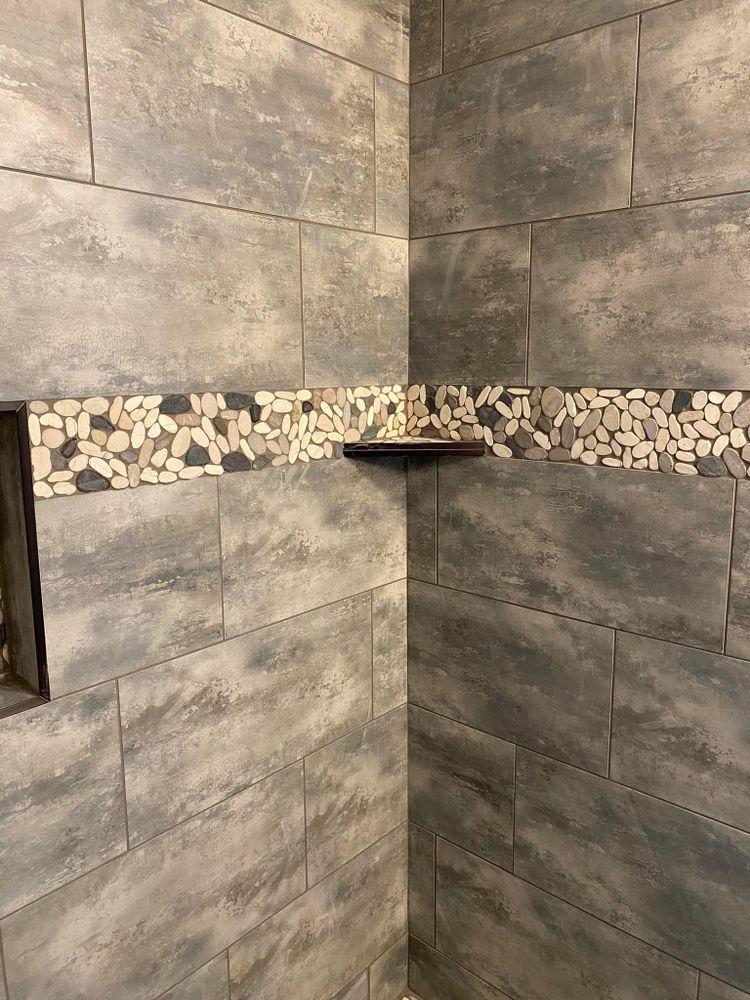 There is a shelf in the corner of the shower.