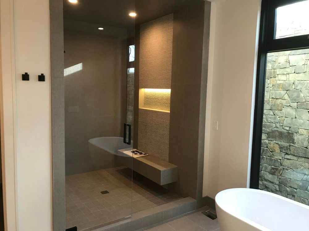 A bathroom with a bathtub and a walk in shower.