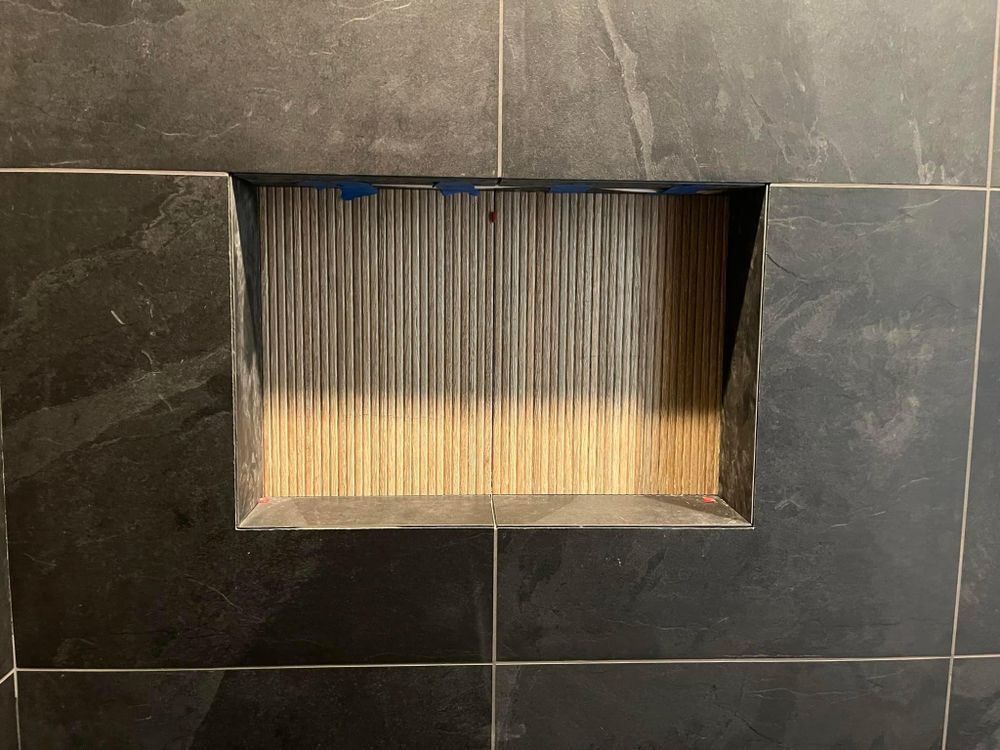 There is a hole in the wall that looks like a fireplace.