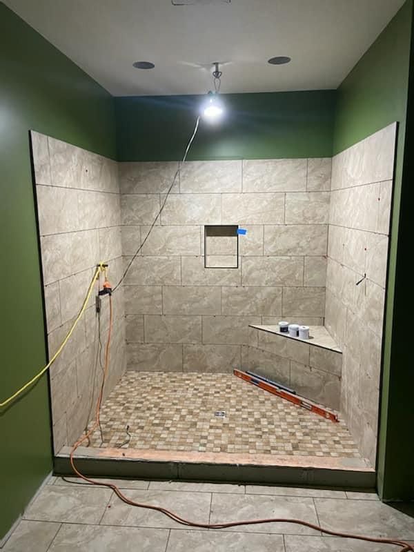 A shower stall is being remodeled in a bathroom.
