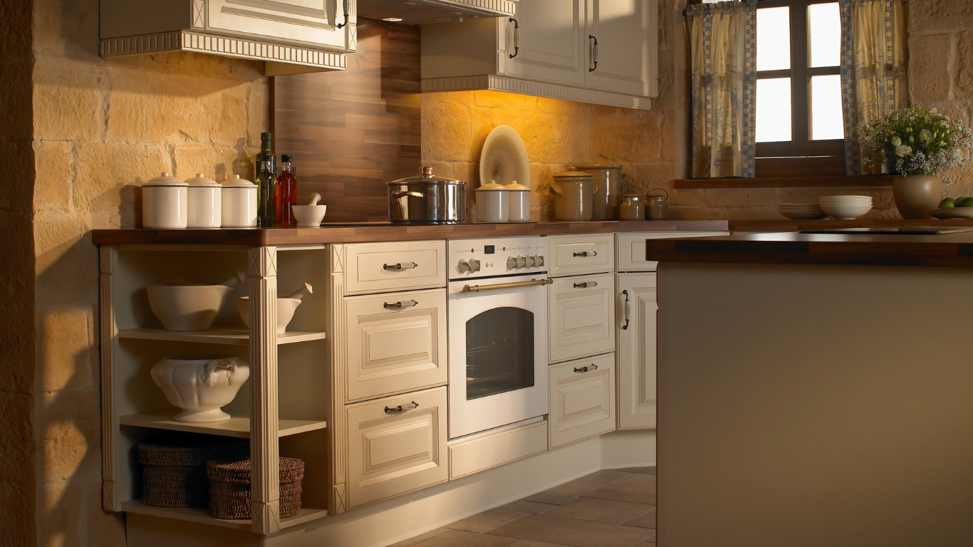 A kitchen with white cabinets and a white stove