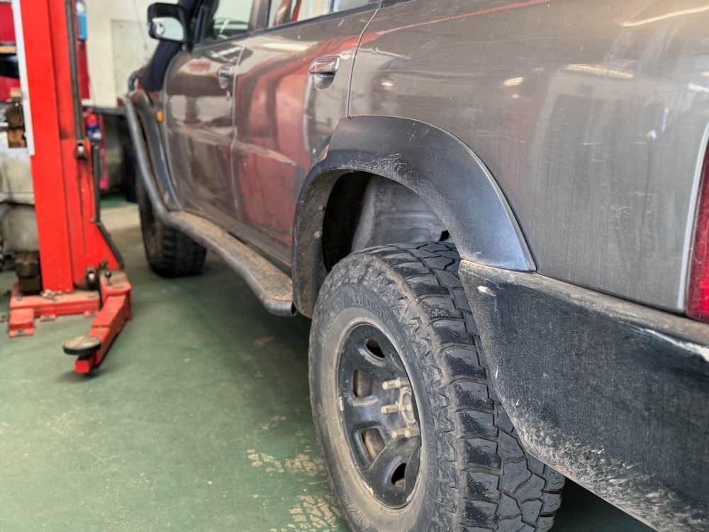 A Truck Is Sitting On A Lift In A Garage — Wayne Devlin Mechanical In Bundaberg Central, QLD