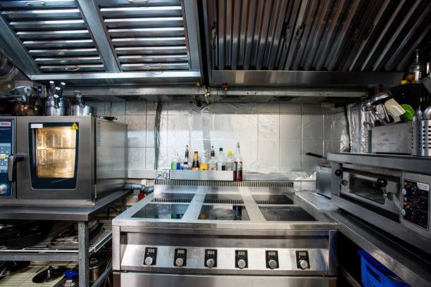 A kitchen with stainless steel appliances and a stove.