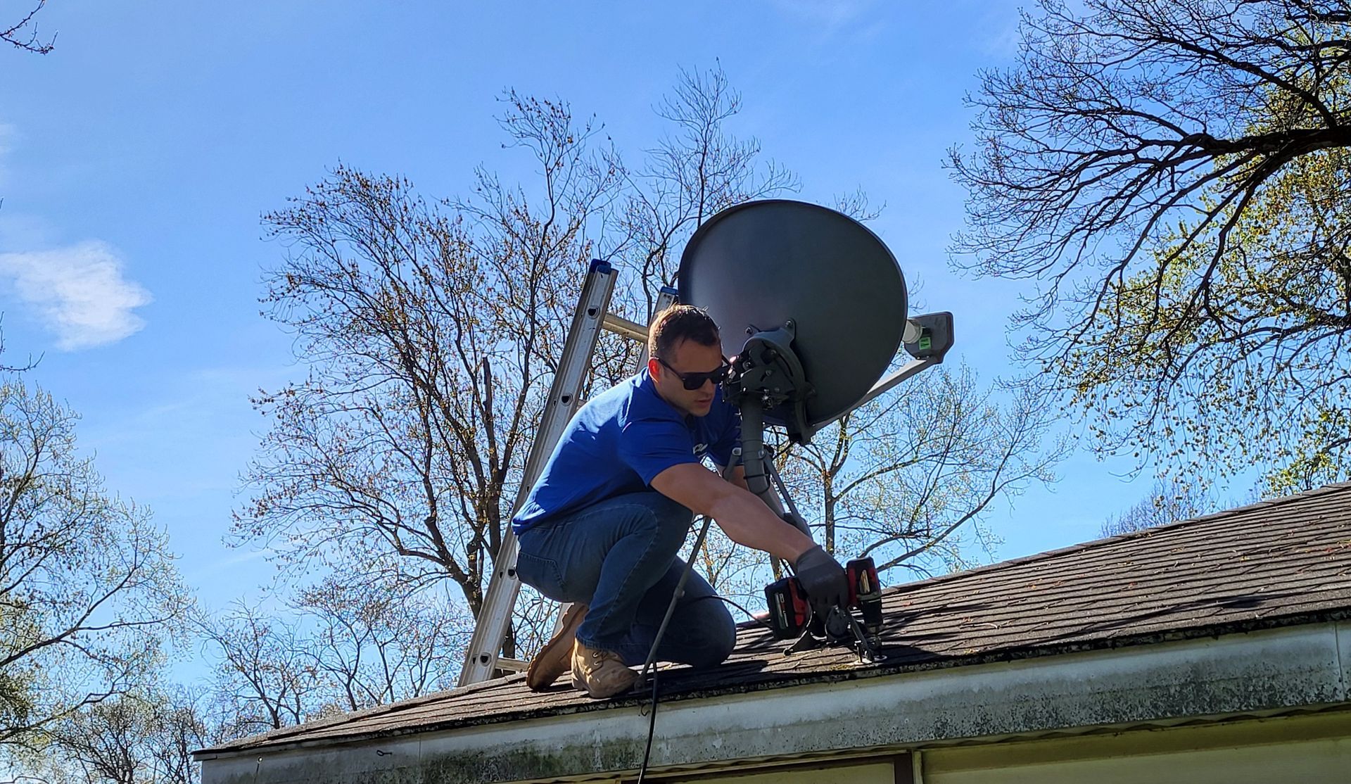 Man In The Roof While Installing The Satellite Dish And Antenna - All Clear Clean Out & Junk Removal Services - Chicago, IL