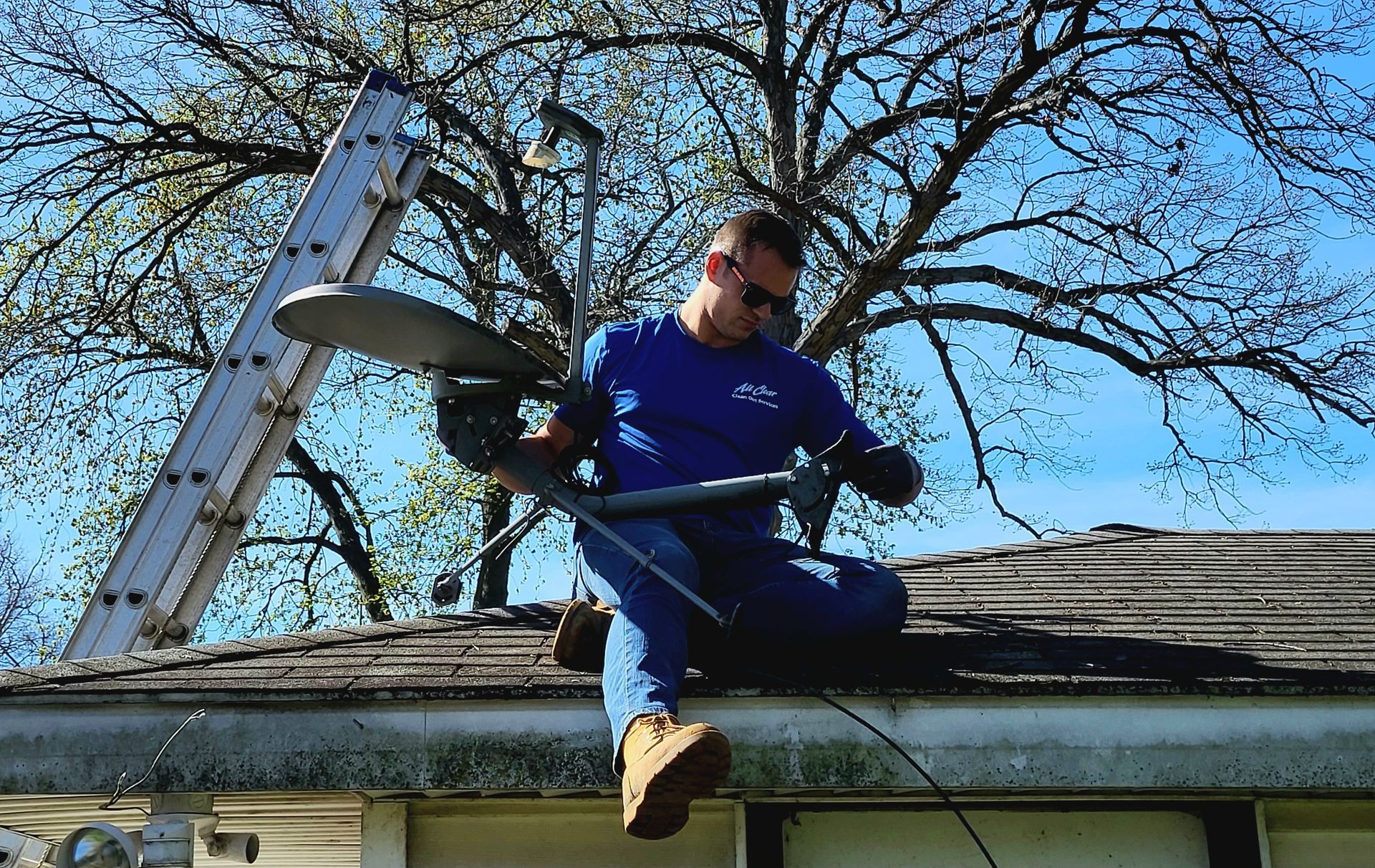 Man In The Roof While Installing The Satellite And Antenna - All Clear Clean Out & Junk Removal Services - Chicago, IL