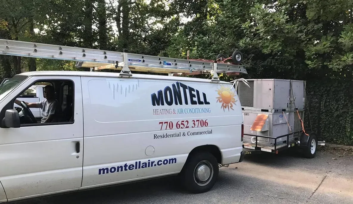 A white van with the word montell on the side is parked in a driveway.