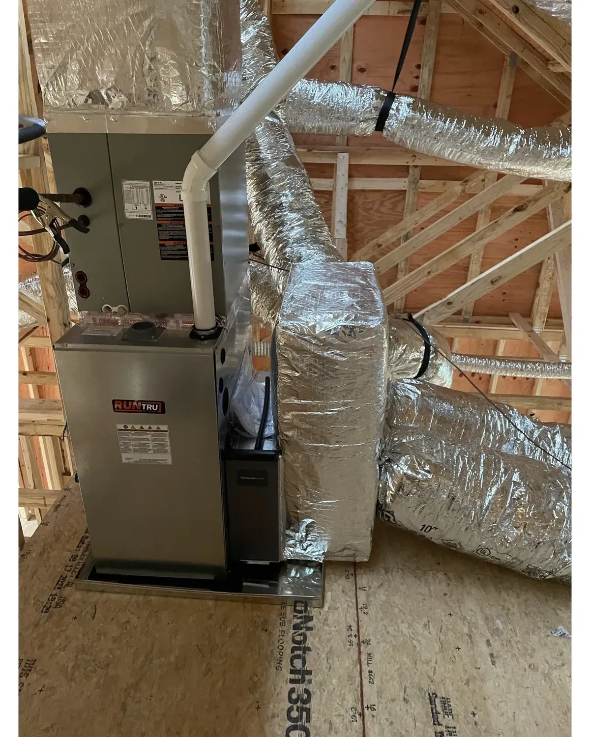 A picture of an air conditioner in a house under construction.
