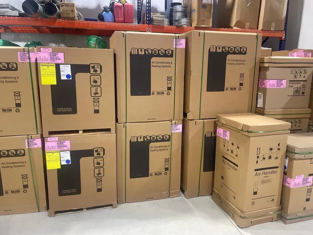 A bunch of cardboard boxes are stacked on top of each other