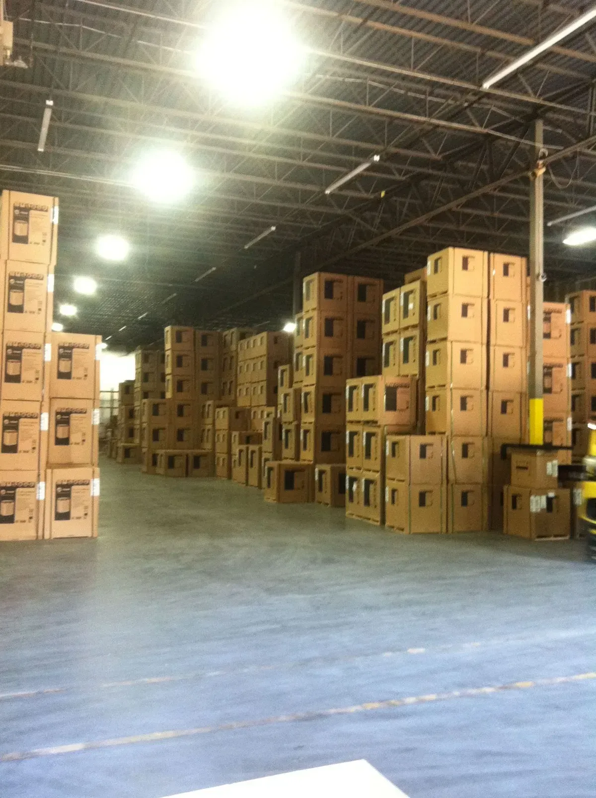 A large warehouse filled with lots of cardboard boxes