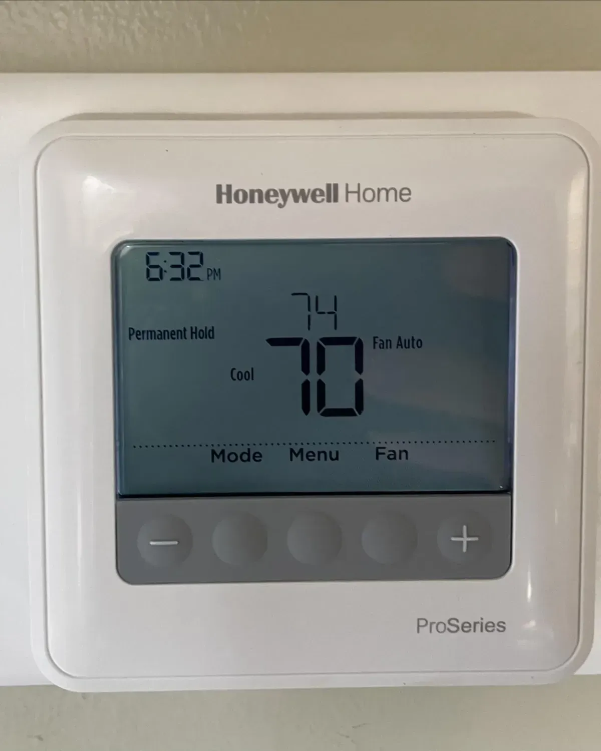 A honeywell home thermostat is set to 70 degrees