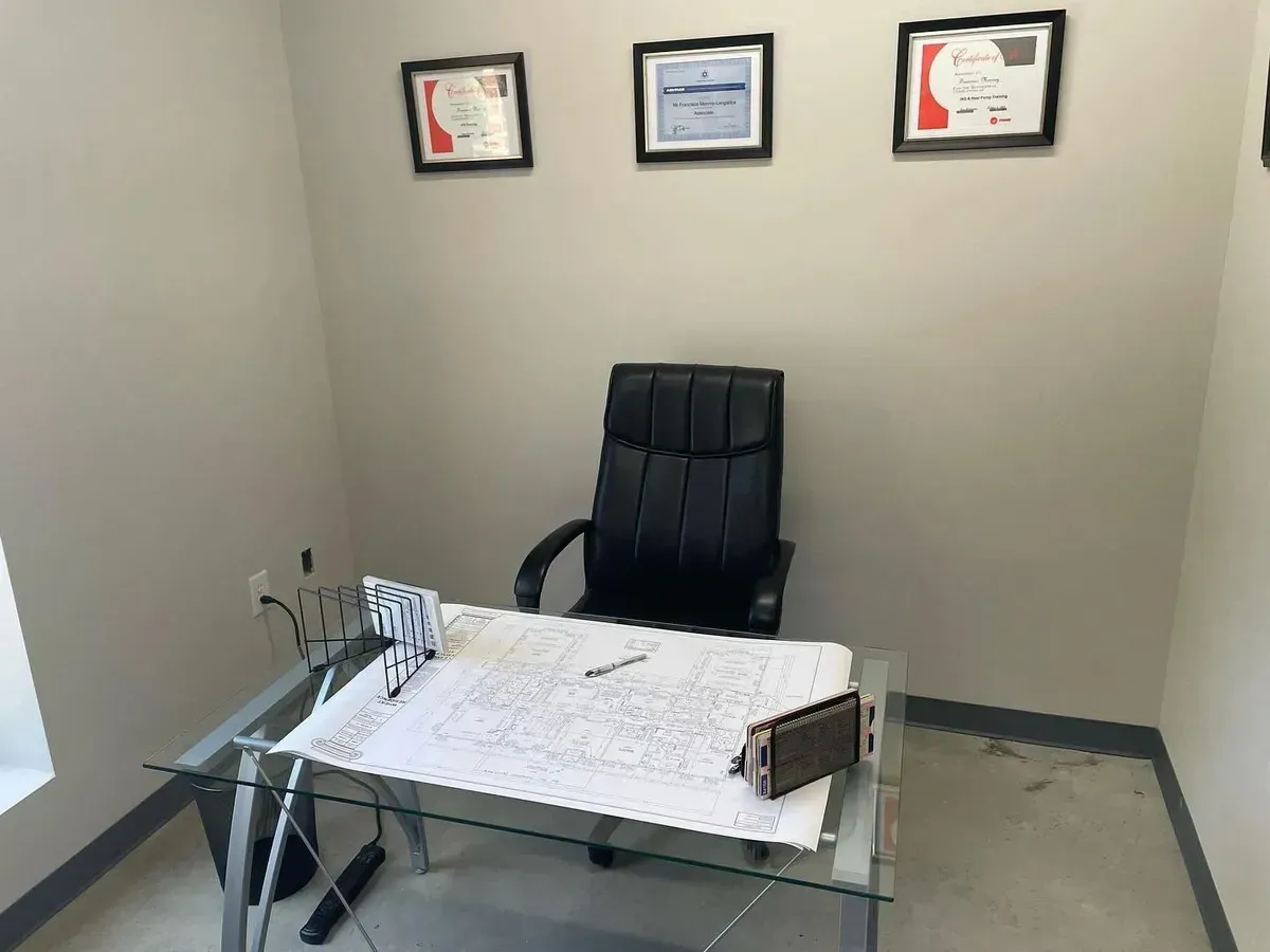 A chair is sitting at a desk in a small office.