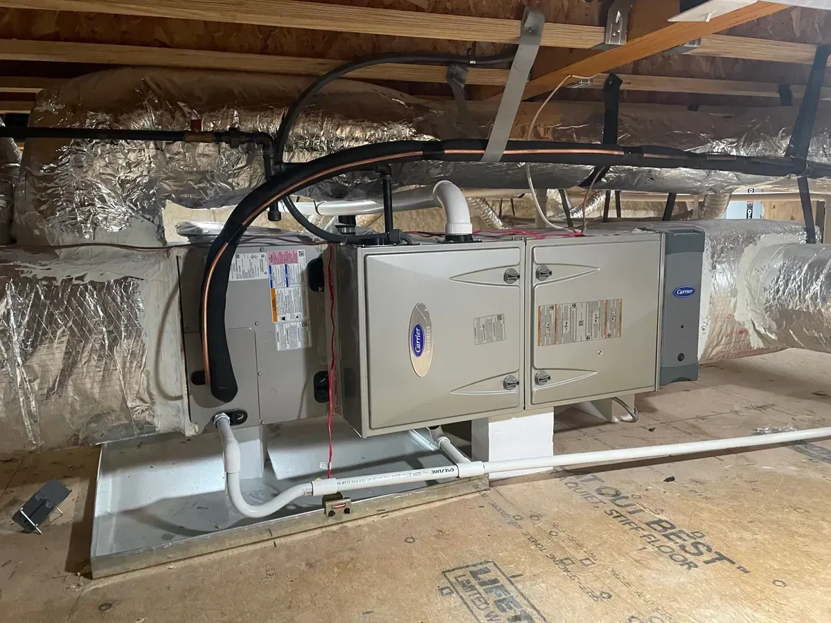 An air conditioner is installed in the attic of a house.