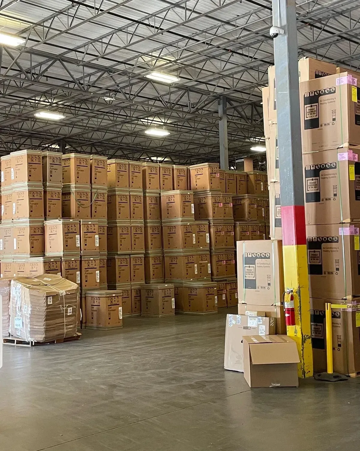 A large warehouse filled with lots of cardboard boxes
