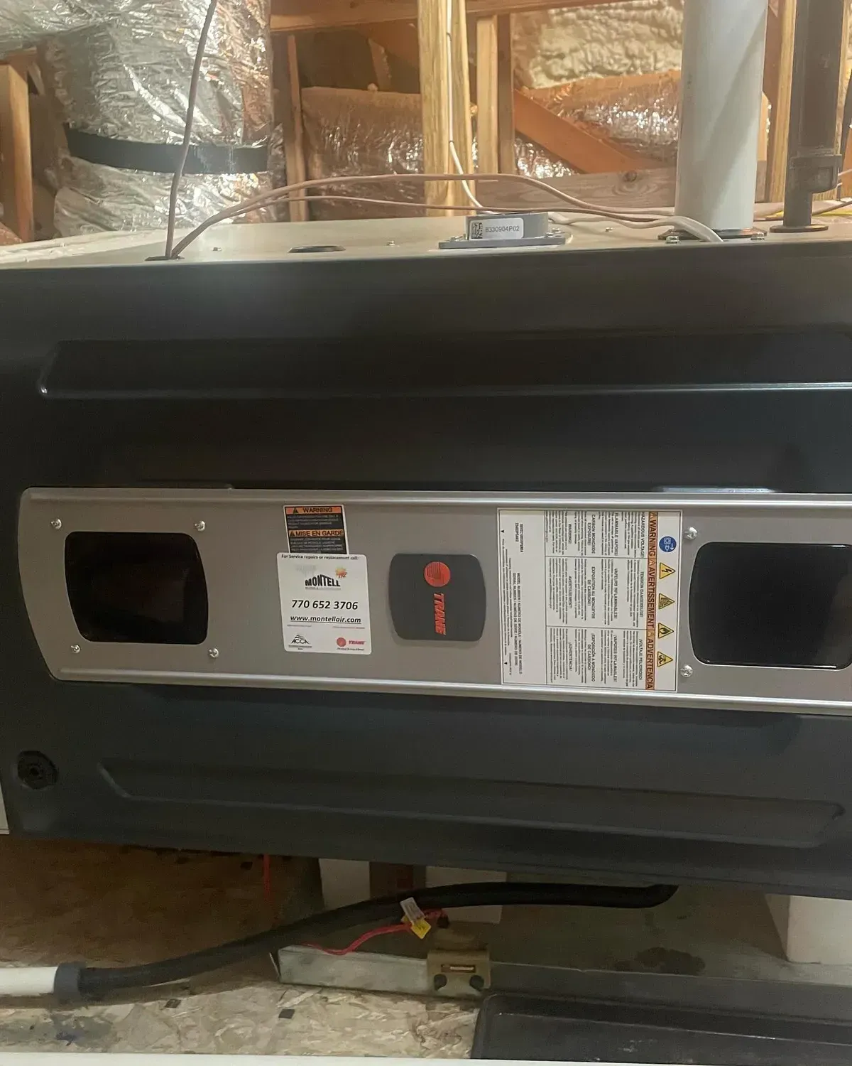 A black heater is sitting on the floor in a room.