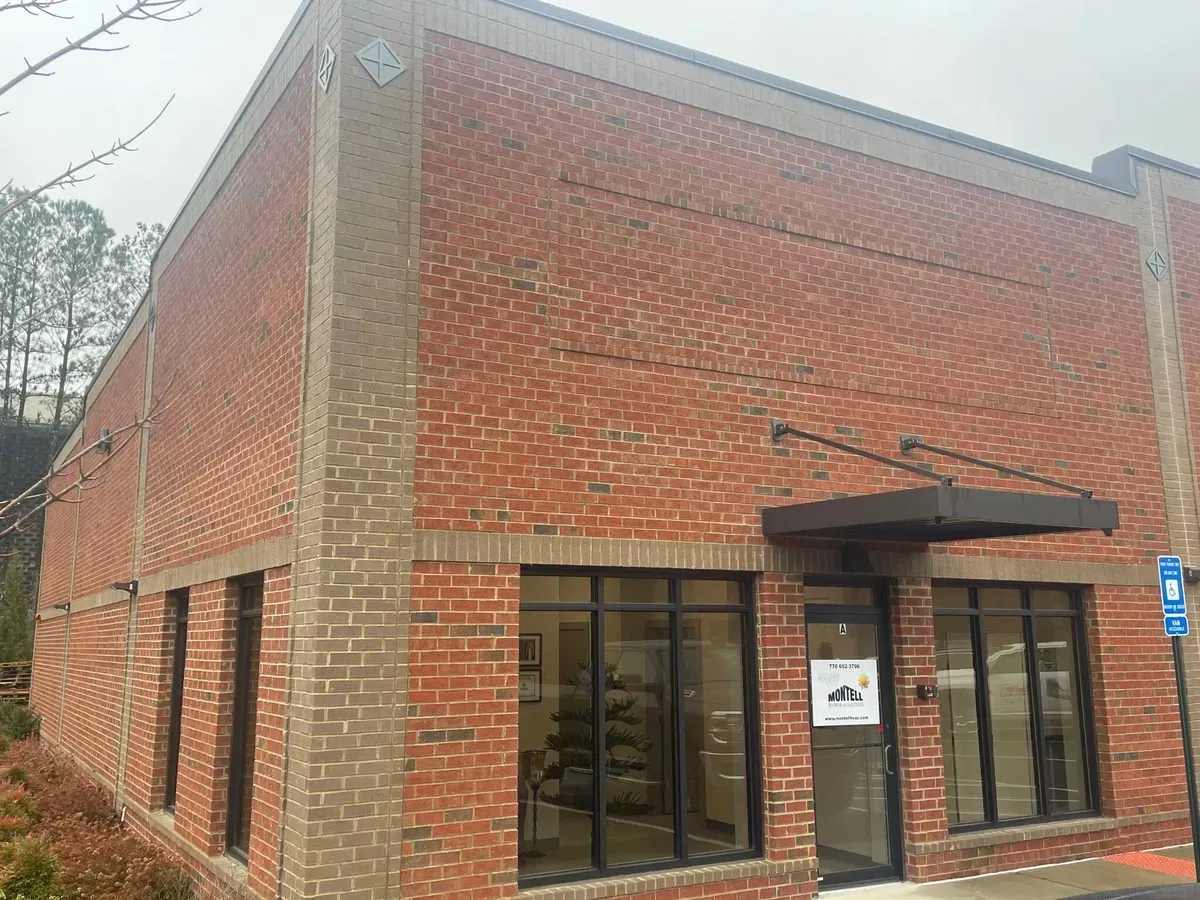 A brick building with a canopy over the door and windows.