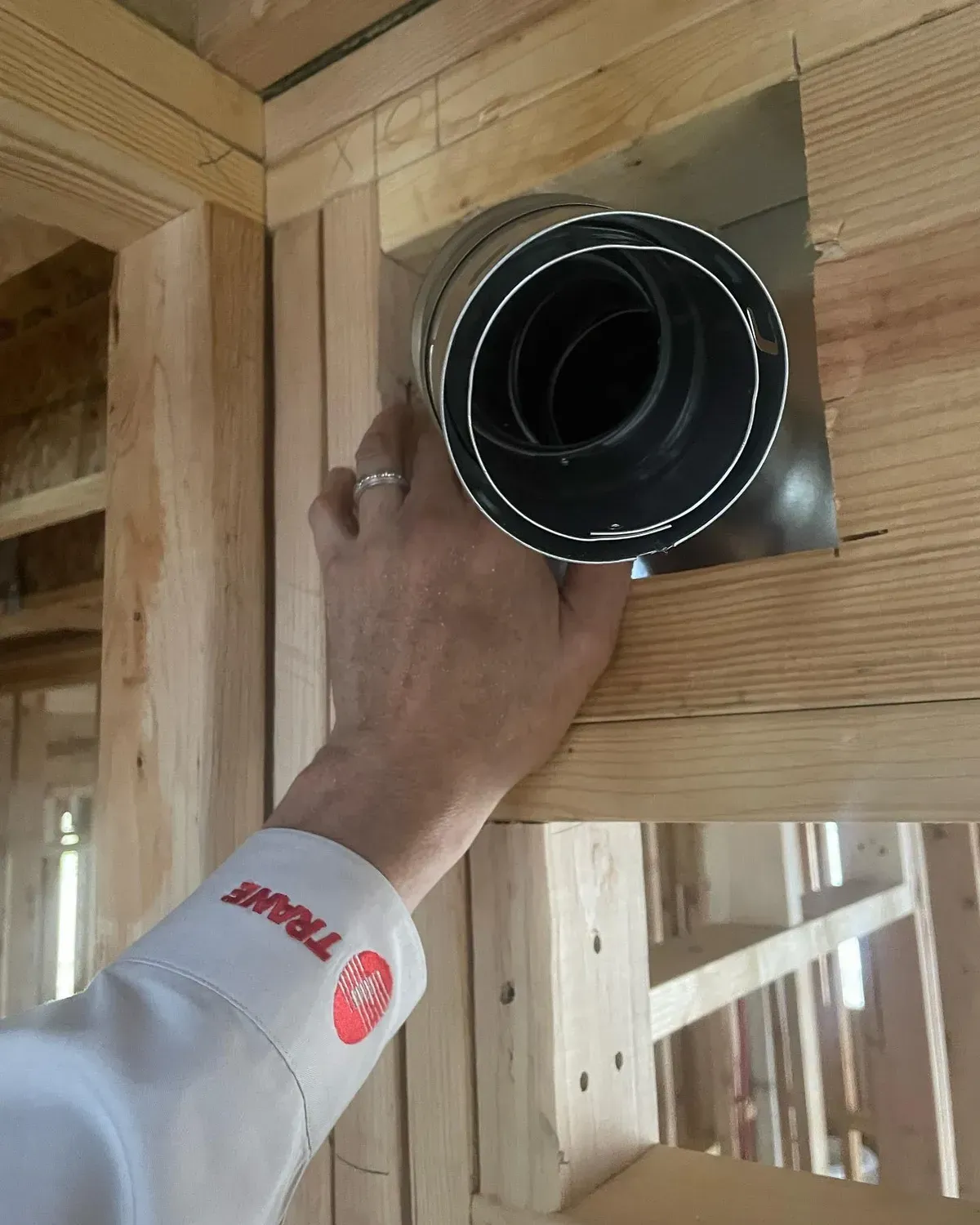 A person wearing a shirt that says trane on it