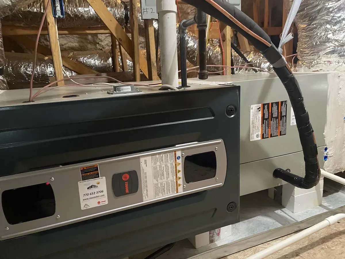 An air conditioner is sitting in the attic of a house.
