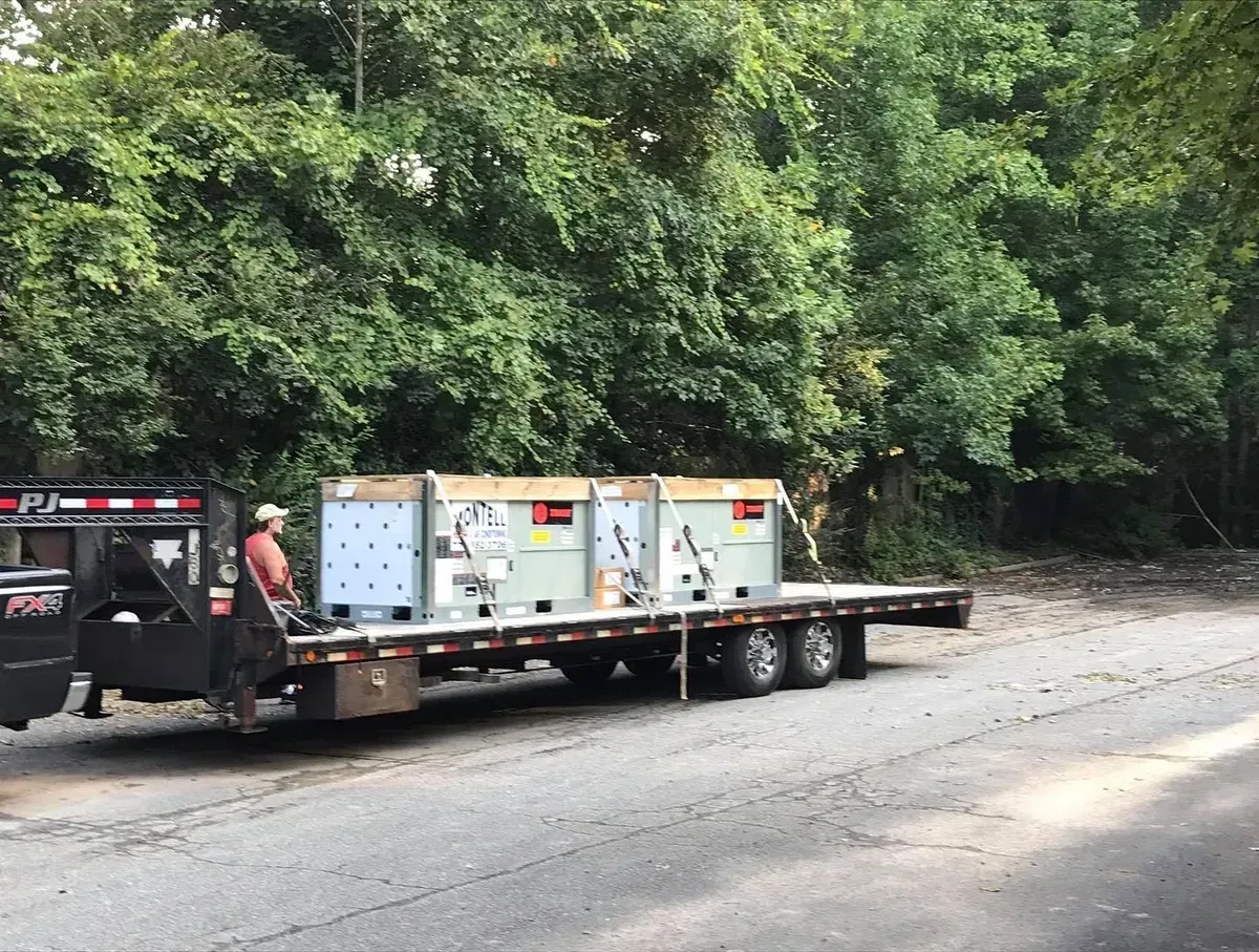 A flatbed truck with boxes on the back is parked on the side of the road.