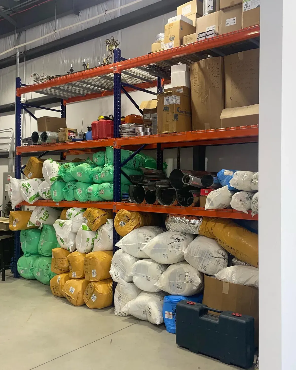 A warehouse filled with lots of bags and boxes on shelves.