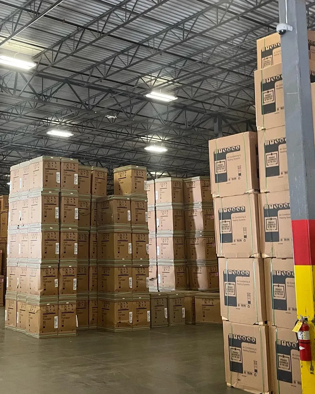 A large warehouse filled with lots of boxes and a fire extinguisher