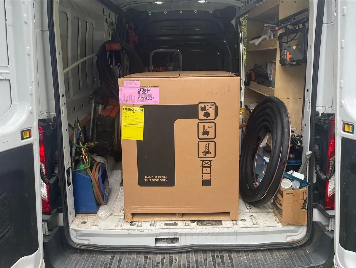 A large box is sitting in the back of a van.