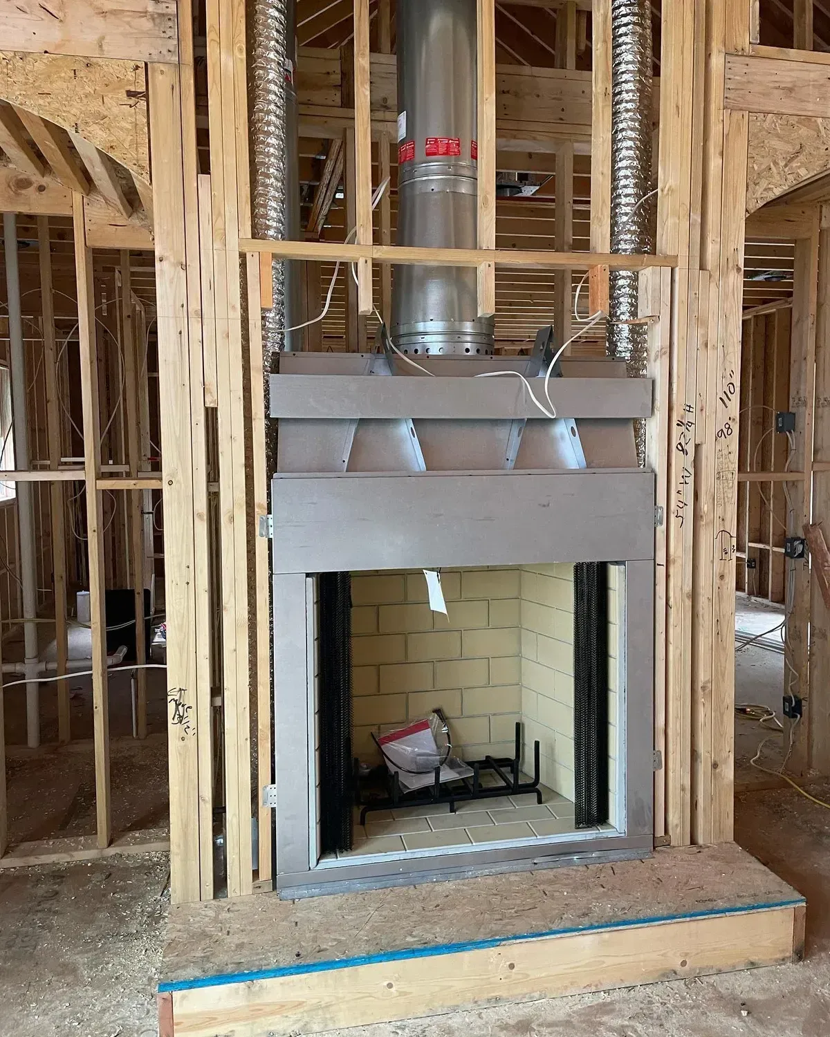 A fireplace is being built in a house under construction
