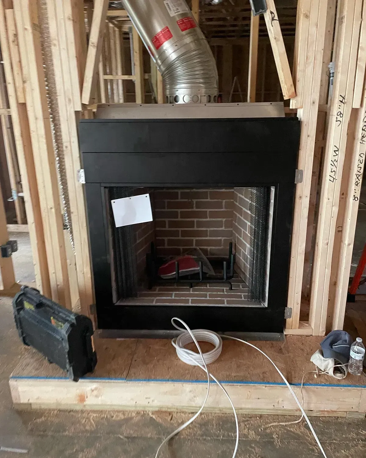 A fireplace is being built in a house under construction.