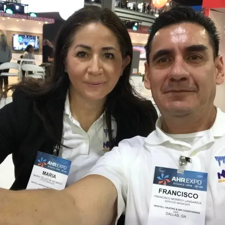 A man and a woman are posing for a picture and the man has a name tag that says francisco